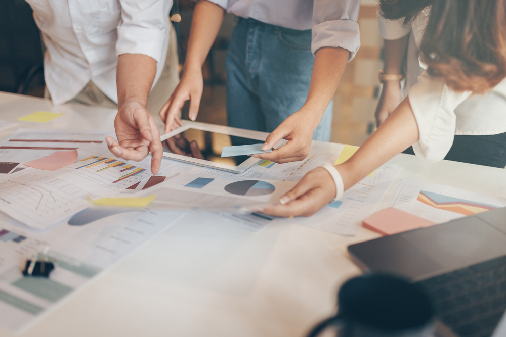 People reviewing data in a boardroom for incentive travel companies